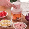 USB rechargeable mini electric food chopper with 250ml bowl, chopping vegetables on kitchen table.