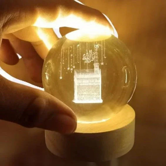 Crystal ball night lamp with Khana Kaaba 3D design, glowing on a wooden base