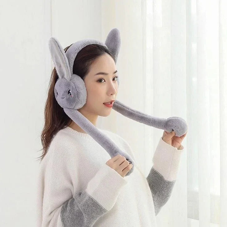 Woman wearing cute grey rabbit earmuffs hat with plush moving ears indoors
