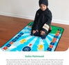 Young child in black praying on colorful interactive prayer mat for kids, touch-sensitive with audio features