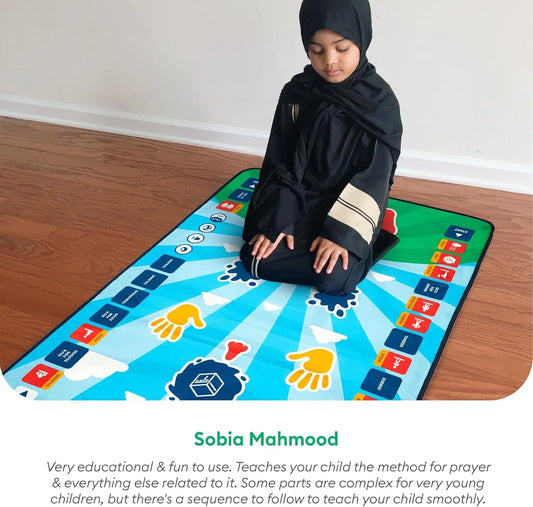 Young child in black praying on colorful interactive prayer mat for kids, touch-sensitive with audio features