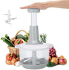 Manual hand push vegetable and meat chopper with stainless steel blades, surrounded by fresh fruits and vegetables.