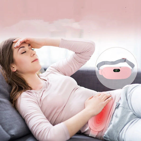 Woman using menstrual pain relief heating waist belt while lying on sofa