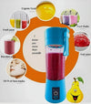 Blue portable mini juicer blender with pink smoothie, fresh juice, fruit shake, and face mask uses.